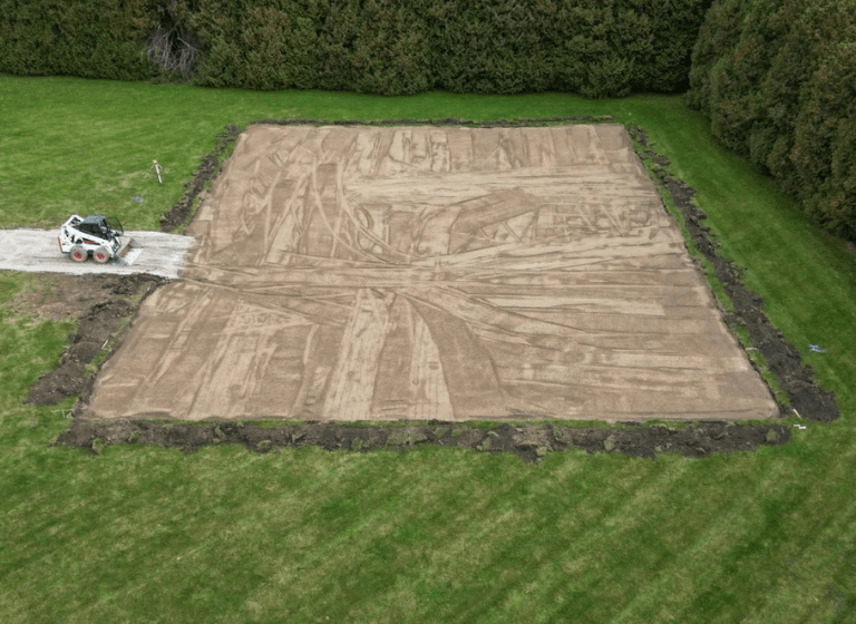 Construction site with grading, drainage, and soil compaction for a steel building foundation in Ontario