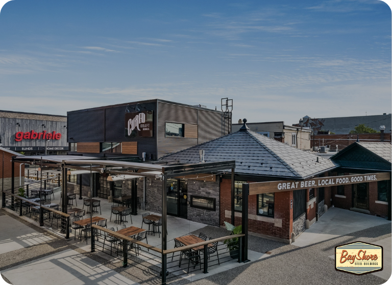 modern steel restaurant building exterior with patio seating